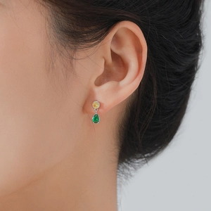 Elegant S925 silver stud earrings with yellow round and green teardrop zircons on model