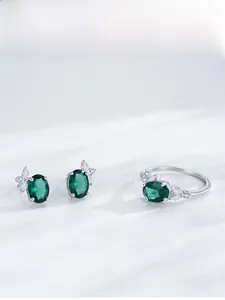 Detailed view of S925 silver emerald ring and earrings set with leaf-shaped zircon