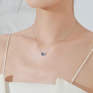 Elegant S925 sterling silver necklace with blue zircon pendant shown on model neck