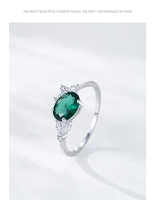 Macro view of S925 silver ring featuring an oval emerald zircon and shimmering white stones