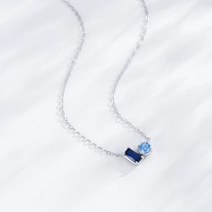 Elegant S925 sterling silver necklace with blue zircon pendant on minimalist white background