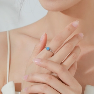 Elegant S925 sterling silver ring with a round blue floral gemstone and side diamonds