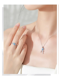 Detailed close-up of S925 silver bow ring and necklace set with blue pear gemstones