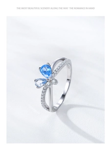 Detail of S925 sterling silver ring featuring blue zircon butterfly and micro-set diamonds