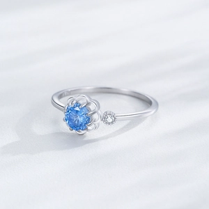 Elegant S925 sterling silver flower ring featuring a vibrant blue zircon and side stone