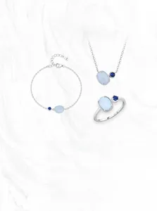 Close-up of S925 sterling silver jewelry set with light and dark blue opal gemstones