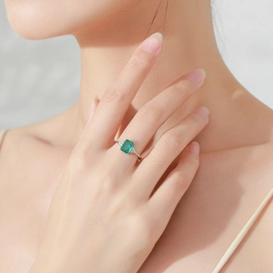 S925 sterling silver ring featuring emerald cut green zircon and small side diamonds