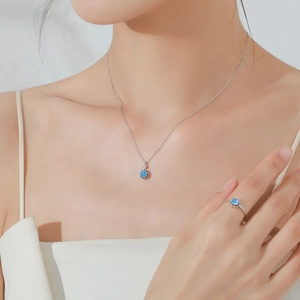 Elegant S925 sterling silver jewelry set with sky blue gems worn by a model