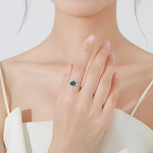 Elegant S925 silver ring featuring oval emerald zircon and pear side stones on hand