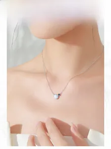 Model wearing a delicate S925 silver necklace with oval opal pendant on neckline