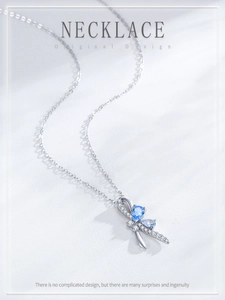 Macro detail of S925 silver bow pendant necklace with teardrop blue gemstones