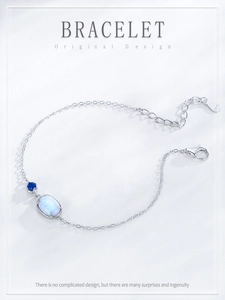 Close-up of S925 sterling silver chain bracelet with blue gemstone and oval opal stone