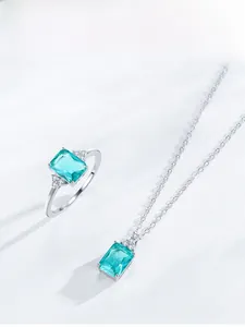 Detail view of S925 silver necklace and ring set with emerald cut green gemstones