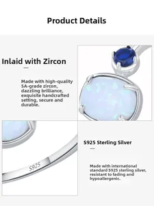 Detail view of S925 sterling silver ring featuring blue zircon and oval opal stones