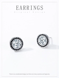 Macro shot of S925 sterling silver studs with brilliant zircon and black gem halo