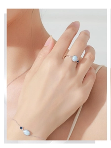 Macro shot of silver ring and bracelet set featuring elegant light blue opal stones