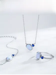 Detail view of S925 silver jewelry set featuring oval opal stones and blue gemstones