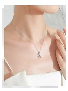 Close-up of S925 silver necklace with blue gemstone pendant and delicate bow ribbon design