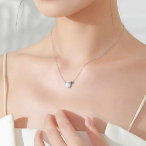 S925 sterling silver oval opal necklace with blue gem on model neck