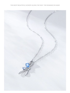 Macro view of S925 silver bow pendant with blue teardrop zircon and delicate chain
