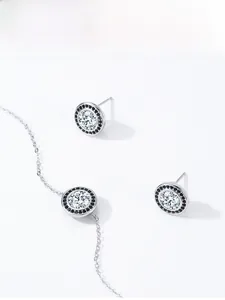 Detailed view of S925 silver necklace and earrings set with black and white zircon stones
