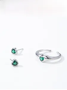Detail of S925 silver ring and earrings set with heart-shaped green zircons