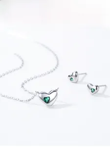 Detail of S925 silver heart jewelry set with green crystals including necklace and earrings