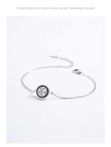 Detailed view of S925 silver bracelet with black and white zircon circular pendant
