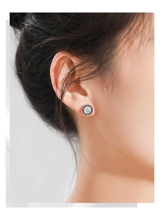 Macro detail of S925 sterling silver stud earring with white zircon and black crystal halo