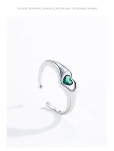 Detailed view of S925 sterling silver ring with heart green zircon and open band