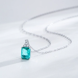 Elegant S925 sterling silver necklace with emerald-cut dark green gemstone and small zircon
