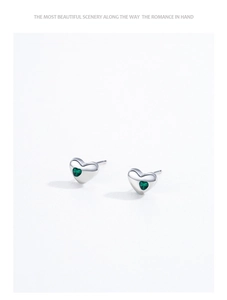 Macro shot of S925 sterling silver heart studs featuring vibrant green zircon stones