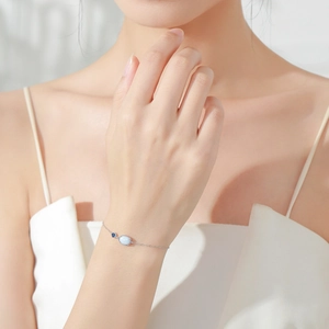 Minimalist S925 silver bracelet featuring an oval iridescent blue opal on a slim chain
