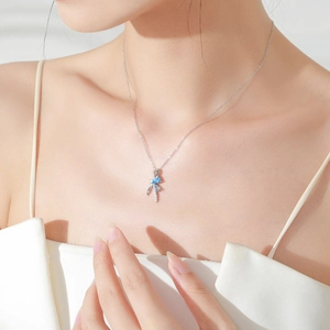 Elegant S925 silver bow necklace with light blue gemstone and delicate ribbon pendant