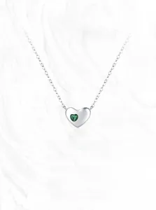 Detail shot of a S925 sterling silver heart necklace with a green zircon pendant