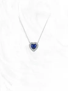 Macro shot of S925 silver necklace featuring a blue heart gemstone with zircon halo