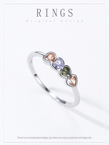 Macro shot of 925 silver ring featuring four colorful heart-shaped cubic zirconia