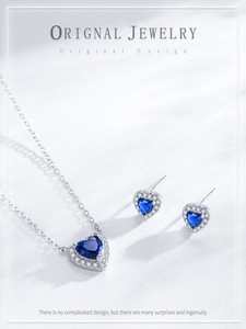 Detailed view of S925 silver heart jewelry set with blue heart-cut stones and crystal halo