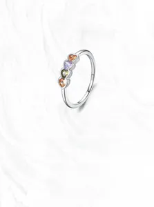 Detailed macro view of S925 silver ring featuring four heart-shaped colored gemstones