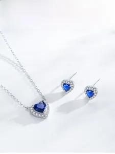 Detail of 925 sterling silver heart-shaped jewelry set with blue cubic zirconia stones