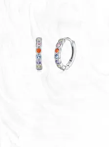Macro detail of S925 silver hoop earrings featuring colorful rainbow zircon gemstones