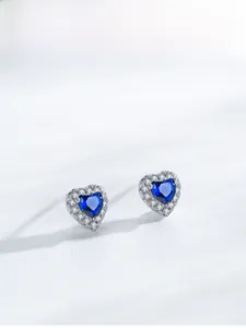 Detail of S925 silver heart earrings featuring deep blue zircon and diamond halo