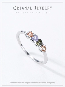 Detail of S925 silver ring featuring colorful heart-shaped champagne and purple stones