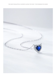 Detailed view of S925 silver heart necklace with blue sapphire and pavé cubic zirconia