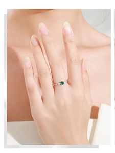 Close-up of S925 sterling silver ring with green emerald gemstone on finger
