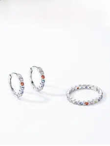 Detailed macro of S925 sterling silver rainbow earrings and ring set with color zircons