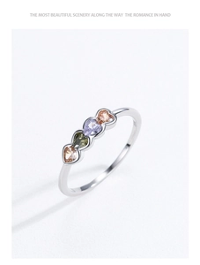 Detail of S925 sterling silver ring with colorful heart zircons and wave design