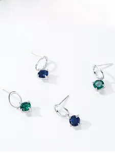 Detail of S925 silver stud earrings with emerald and sapphire blue round zircons