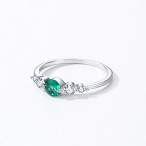 Elegant S925 sterling silver ring with a round green gemstone and white side stones
