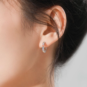 925 Sterling Silver hoop earrings with rainbow gemstones shown on model ear